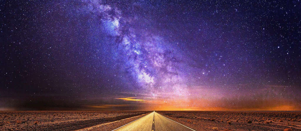 Straight desert road at night